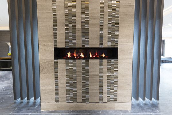 a fireplace in a living room with pillars