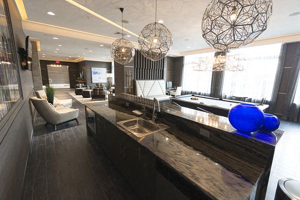 a lobby with a bar and chairs and lights