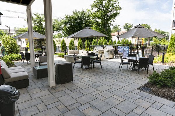 a patio with tables and chairs and umbrellas
