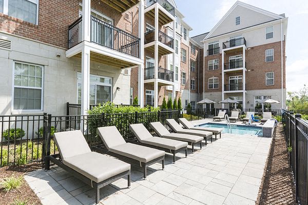 a group of beach chairs sitting next to a pool