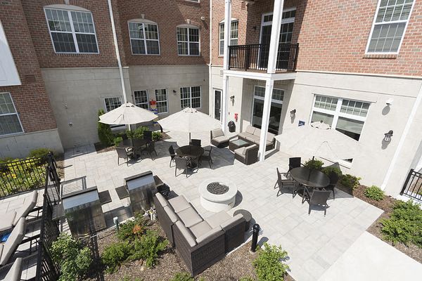 an aerial view of a courtyard with furniture and umbrellas