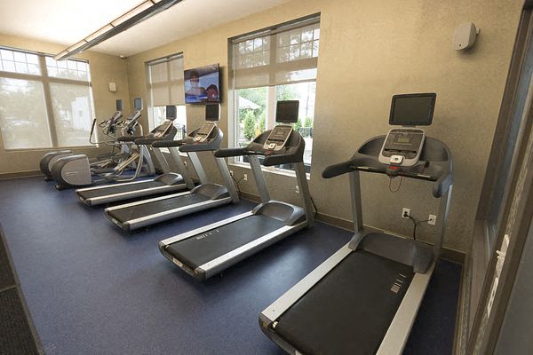 a group of exercise machines in a fitness room