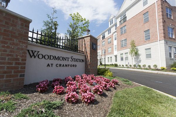 a sign station at cranbrook in front of a building