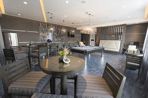 a living room with a table and chairs