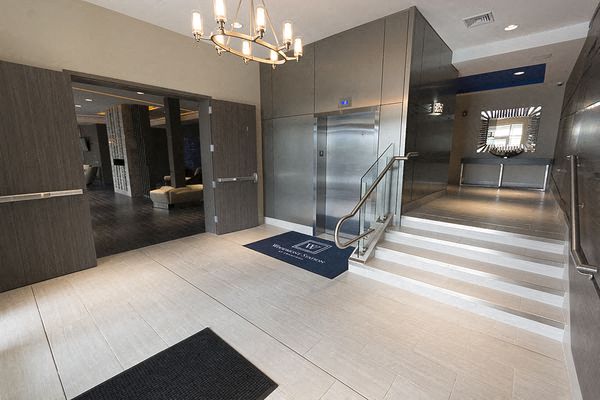 a large lobby with a staircase and a chandelier