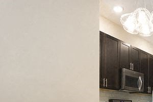 a kitchen with a table and chairs and a refrigerator