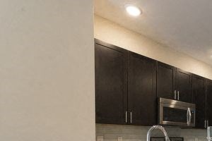 a kitchen with a sink and a refrigerator