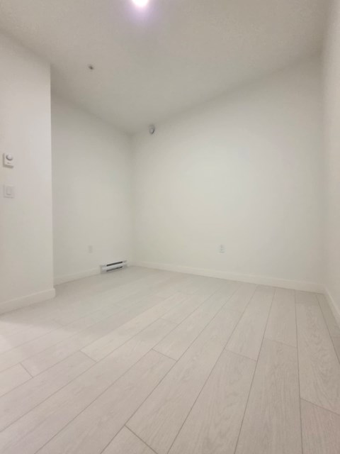 A white room with a light on the ceiling.