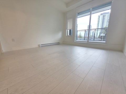 A room with a window and a radiator on the wall.