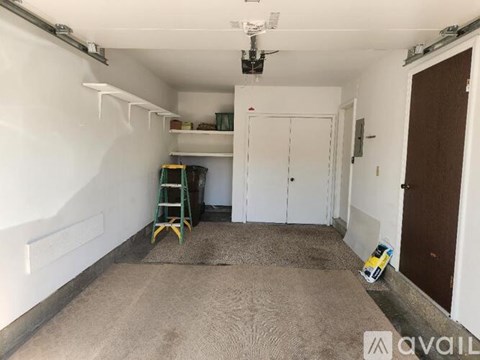 A room with white walls and a ceiling fan is available for rent.