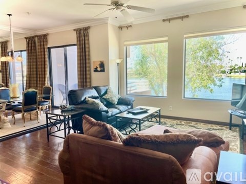 A living room with a brown leather couch and a black coffee table.