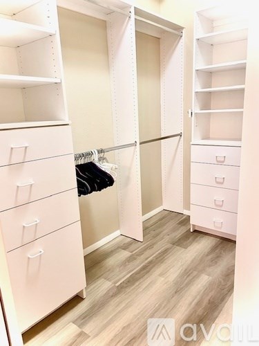A white closet with drawers and shelves.