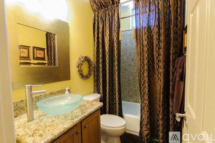 A bathroom with a toilet, sink, and shower.