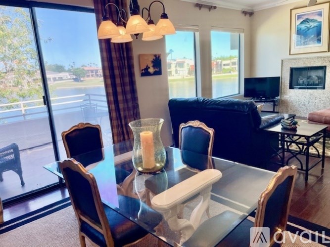 A modern dining room with a glass table and chairs.