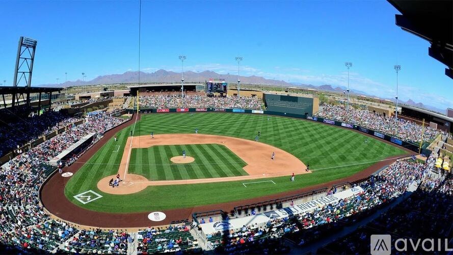 A baseball stadium is filled with spectators watching a game.