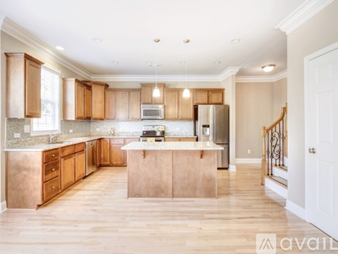 A kitchen with wooden cabinets and a central island.