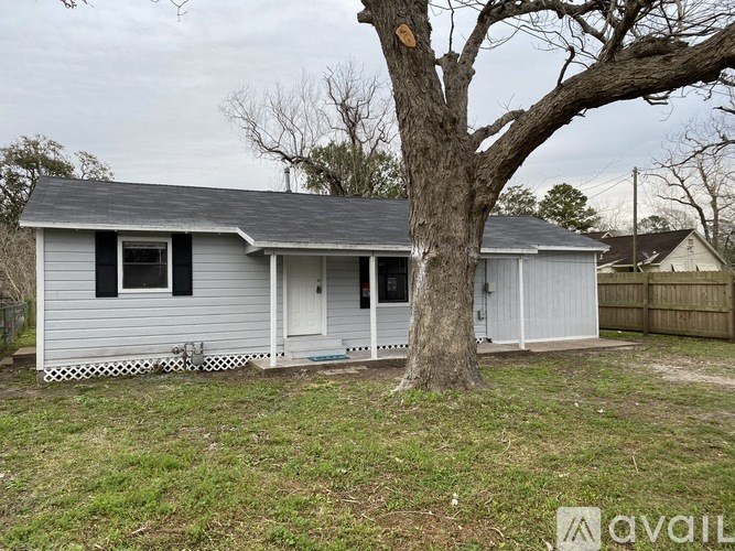A small house with a tree in front of it.