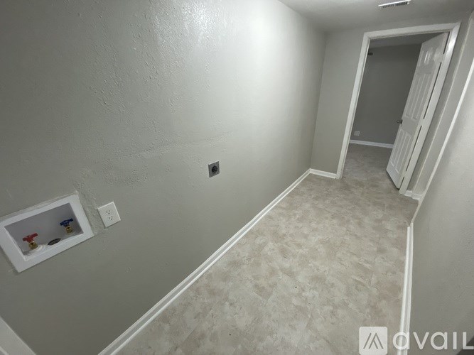 A small room with a white door and a window with a white frame.