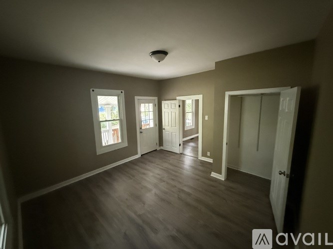 A room with a wooden floor and a ceiling fan.