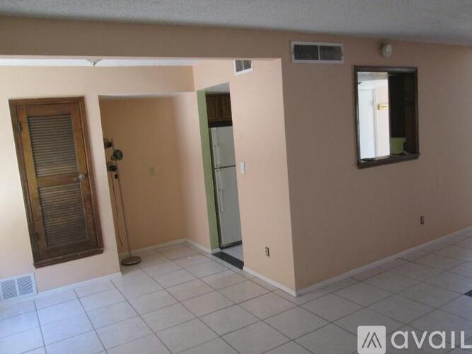 A room with a door, a window, and a mirror.