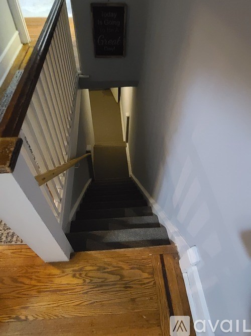 A staircase with a chalkboard on the wall.