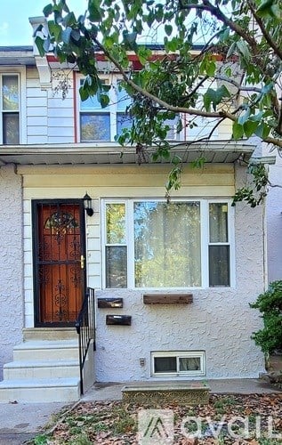 A house with a brown door and a mailbox on the wall.