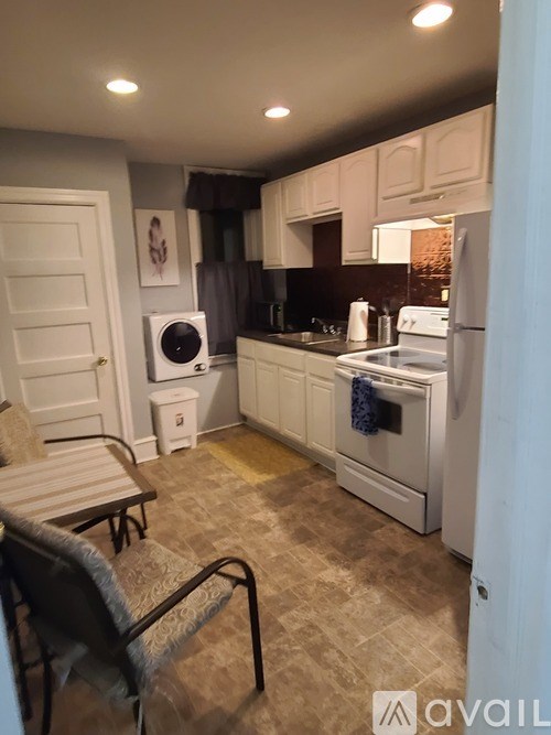 A kitchen with a white oven and a washing machine.