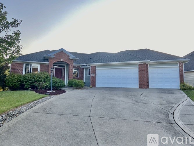 A house with a grey roof and a white garage door.