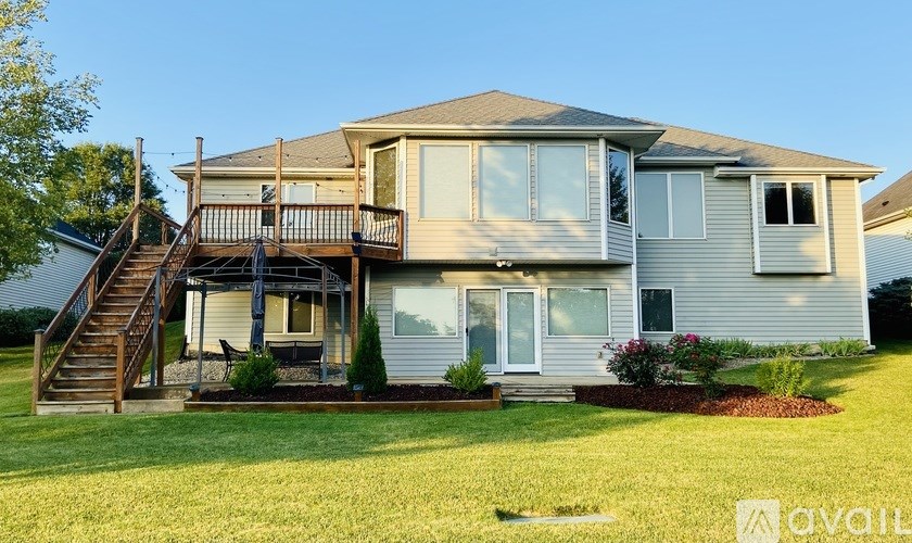 A house with a deck and a staircase leading to it.