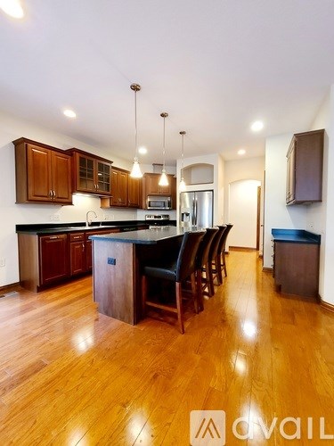 A kitchen with wooden floors and a center island.