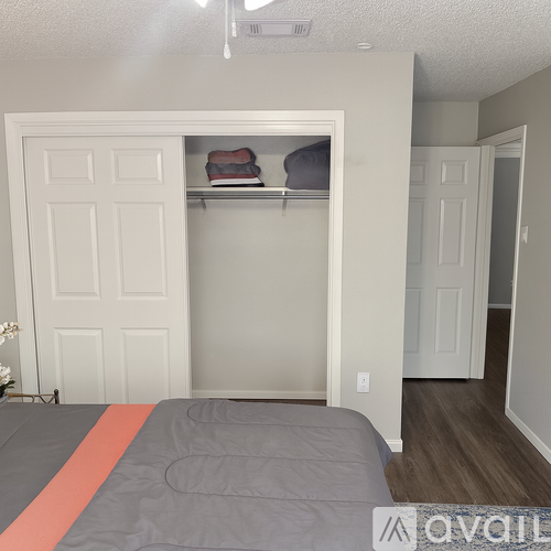 A bedroom with a bed and a closet.