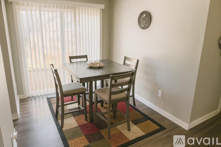 A dining room with a table and chairs.