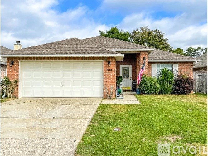 A house with a white garage door and a brick exterior.
