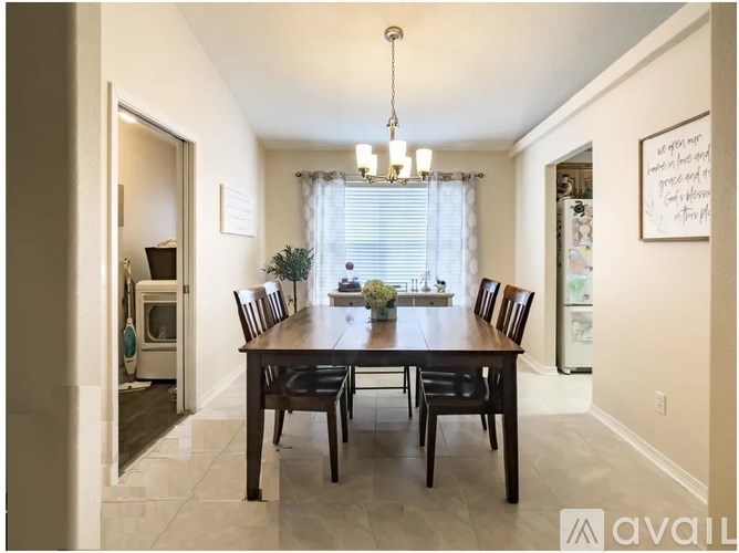 A dining room with a wooden table and chairs.