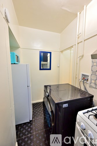 A small kitchen with a black fridge and a black stove.