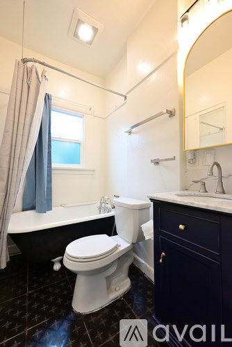 A bathroom with a toilet, sink, and bathtub.