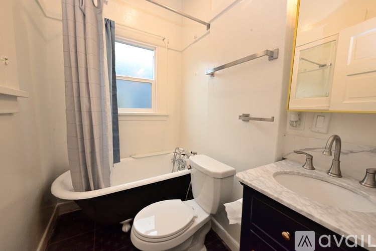 A bathroom with a toilet, sink, and bathtub.