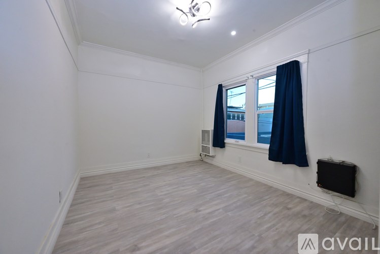 A room with a window and a wall-mounted air conditioner unit.