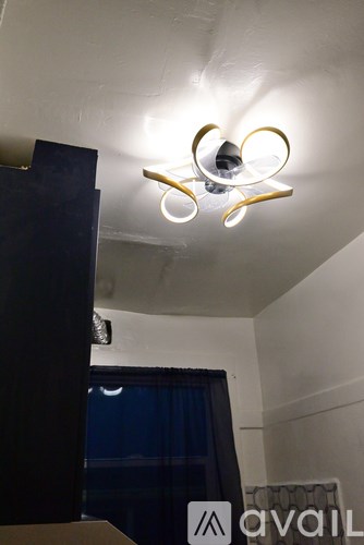 A modern chandelier hangs from the ceiling in a room.