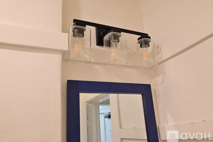 Three light bulbs are hanging from a black track.