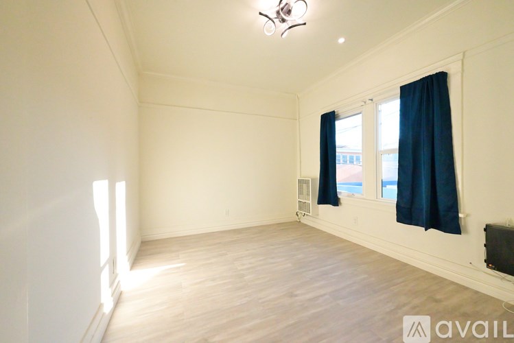 A room with a window and a ceiling fan.