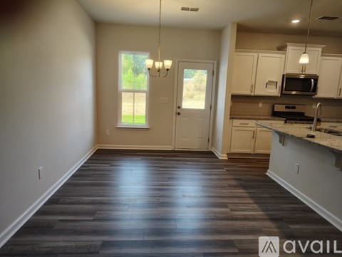 A kitchen area with a counter and cabinets.