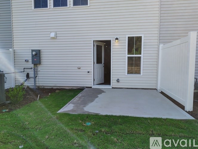 A house with a grey exterior and a white fence.