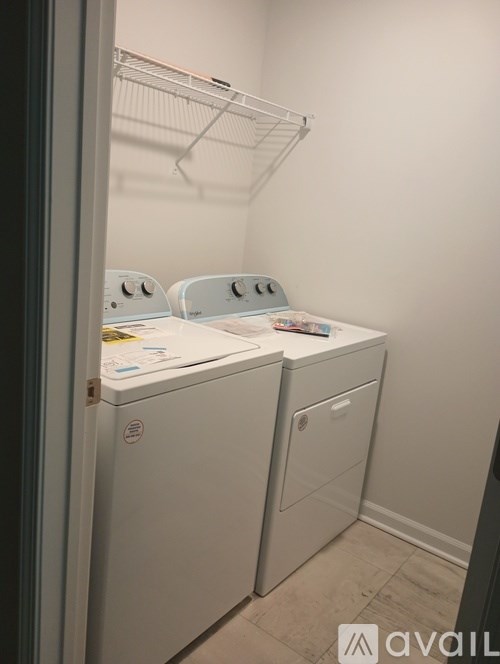 A white washing machine and dryer in a laundry room.