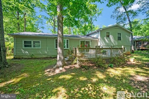 A house with a fence and trees around it.