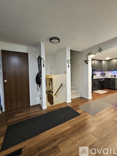 A bathroom with a sink, mirror, and lighted mirror.