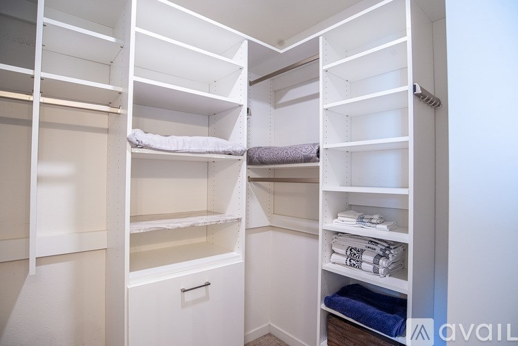 A white bunk bed with a drawer underneath it.
