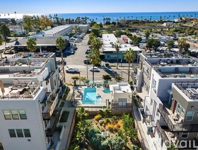 A view of a residential area with apartment buildings and a pool.
