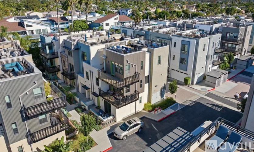 A car is parked in a parking lot in front of a building.
