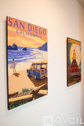 Two posters, one of San Diego and one of Coronado, are hanging on a wall.
